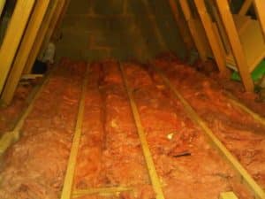 Asbestos insulation in a loft before loft boarding is installed