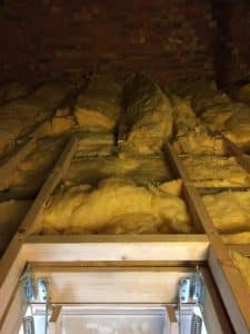 beofre image of loft insulation before boards are put down to increase storage space